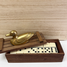 Load image into Gallery viewer, Inside of the wood box that contains dominos and has a brass duck on the lid of the box