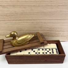 Load image into Gallery viewer, A look inside the wood box that contains dominos and the lid of the box has a brass duck on top