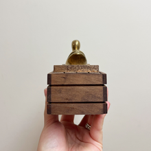 Load image into Gallery viewer, The side of the wood box that has a brass duck on top and contains a set of dominos