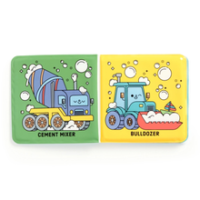 Load image into Gallery viewer, The inside pages of a bath book shown open flat, featuring two black line drawings of construction vehicles: a cement mixer on the left and a bulldozer on the right, each with bubbles around them and the vehicle names printed below. The color has been activated by dipping the pages in water.