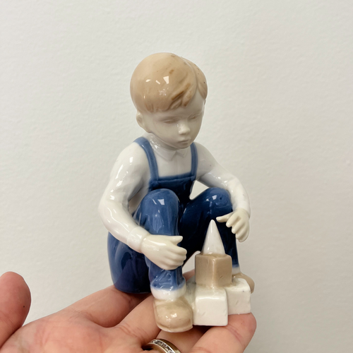 pastel colored figurine of a boy playing with blocks available from the Preloved/Vintage Collection at Gracie Lou