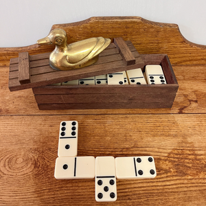 Picture of several of the dominos that come inside the wood box with brass duck figurine on top.