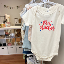 Load image into Gallery viewer, A baby onesie hanging on a clothing rack inside Gracie Lou, A Boutique For Littles, specialty store in Bedford, PA.