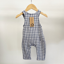 Load image into Gallery viewer, The back view of a baby boy jumpsuit on a wooden hanger in front of a white background inside Gracie Lou, "A Boutique For Littles", children's boutique.