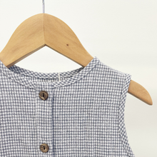 Load image into Gallery viewer, A close up of an infant baby romper with front buttons, hanging on a wooden hanger in front of a white background inside Gracie Lou.