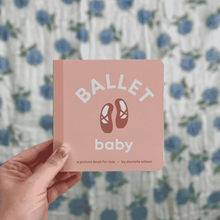 Load image into Gallery viewer, Pink book titled 'Ballet Baby' held in front of a floral-patterned background