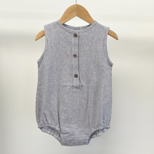 Load image into Gallery viewer, An infant baby romper with front buttons, hanging on a wooden hanger in front of a white background inside Gracie Lou.