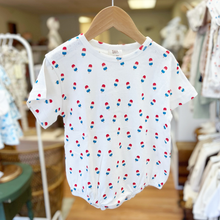 Load image into Gallery viewer, Baby bubble romper, with a repeated bomb pop popsicle pattern, on a wooden hanger, being held up inside Gracie Lou children's boutique.