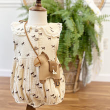Load image into Gallery viewer, A western inspired baby girl bubble romper on a mannequin wearing a horse crossbody purse in front of a fern on a wicker peacock chair.