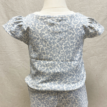 Load image into Gallery viewer, The back of a floral-patterned top and shorts on a mannequin against a neutral background