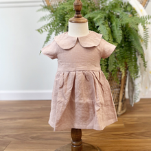 Load image into Gallery viewer, A dusty pink, linen children's dress on a baby size mannequin in front of a green fern on a wicker peacock chair. This item is featured inside Gracie Lou, a children's boutique with locations in Hollidaysburg &amp; Bedford, PA.