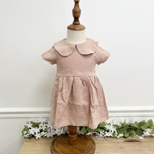 Load image into Gallery viewer, A dusty pink, linen children's dress on a mannequin in front of a white wall.