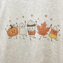 Load image into Gallery viewer, A close-up of a light heather gray fabric featuring a colorful graphic print of five cute, smiling autumn characters: a pumpkin, a ghost, a coffee cup, and a maple leaf, and candy corn accented by small stars.