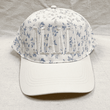 Load image into Gallery viewer, White cap with floral pattern on a gray background