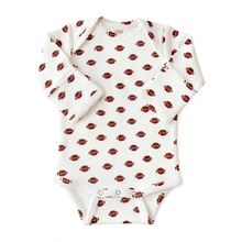 Load image into Gallery viewer, A long-sleeve baby bodysuit in white with an all-over print of brown footballs, shown flat against a white background.