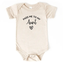 Load image into Gallery viewer, A short-sleeve baby bodysuit in a light beige or cream color, featuring the text 'PASS ME TO MY Aunt' and a heart outline printed in black on the chest.