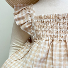 Load image into Gallery viewer, Close-up of a baby mannequin wearing a beige checkered gingham top and bloomers set ruffled sleeves against a neutral background