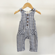 Load image into Gallery viewer, A baby boy jumpsuit on a wooden hanger in front of a white background.