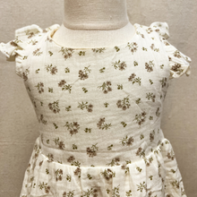 Load image into Gallery viewer, White dress with small floral pattern on a toddler mannequin against a plain background