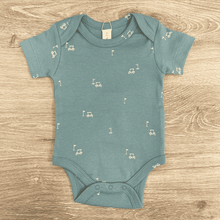 Load image into Gallery viewer, Teal baby onesie with small white golf pattern on a wooden surface
