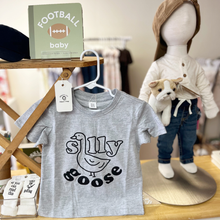 Load image into Gallery viewer, A Silly Goose shirt hanging on a child size wood ironing board alongside other baby and toddler items inside Gracie Lou.