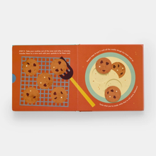 Load image into Gallery viewer, Book with illustrations of cookies on a cooling rack and plate against an orange background