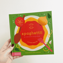 Load image into Gallery viewer, A hand holding a interactive recipe book called 'Spaghetti!' that is part of the Cook in a Book series by Lotta Nieminen