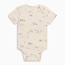 Load image into Gallery viewer, A short-sleeve baby bodysuit in a warm cream color, featuring a delicate all-over print of small boats, trees, and coastal scenes in muted green, blue, and brown tones.