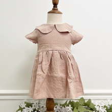 Load image into Gallery viewer, A dusty pink, linen children's dress on a mannequin in front of a white wall.