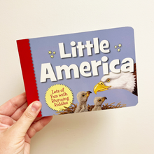 Load image into Gallery viewer, Book titled 'Little America' held by a hand with a beige background