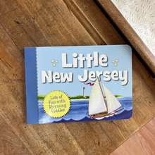 Load image into Gallery viewer, A board book titled ' Little New Jersey' laying on a vintage school desk.
