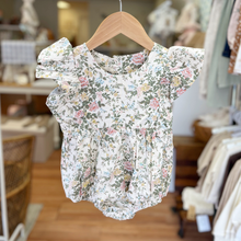 Load image into Gallery viewer, Floral baby romper on a hanger in a store setting