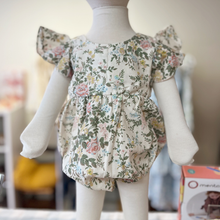 Load image into Gallery viewer, Floral baby romper on an infant mannequin against a blurred background inside Gracie Lou, A Boutique For Littles