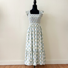 Load image into Gallery viewer, White dress with blue and green floral pattern on a mannequin against a white wall