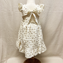 Load image into Gallery viewer, The back of a floral dress on a toddler mannequin against a plain background
