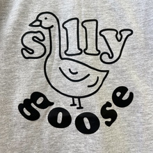 Load image into Gallery viewer, A close up of the front of the Silly Goose tee shirt. The neck of the goose extends up through the word "silly" and replaces the letter "i".