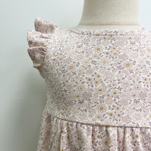 Load image into Gallery viewer, A close up of the flutter sleeve detail on a floral bubble romper styled on a baby mannequin in front of a white wall.