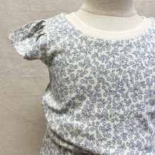 Load image into Gallery viewer, Blue floral patterned organic-cotton shirt on a toddler mannequin against a neutral background