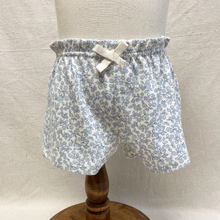 Load image into Gallery viewer, Floral-patterned shorts on a mannequin against a neutral background