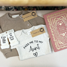 Load image into Gallery viewer, A curated gift set from Gracie Lou featuring a light gray t-shirt with 'PASS ME TO MY Aunt' printed in black, a taupe knit cardigan, white socks with 'If you can read this &amp; take me to my aunt' text, and a pink hardcover journal titled 'Aunt's Story'.