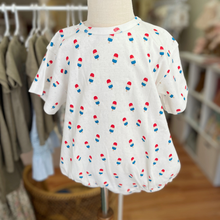 Load image into Gallery viewer, Baby bubble romper, with a repeated bomb pop popsicle pattern, on an infant mannequin inside Gracie Lou children's boutique.