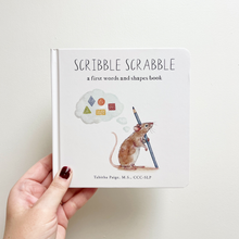 Load image into Gallery viewer, Book titled 'Scribble Scrabble' held by a hand on a light background