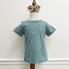 Load image into Gallery viewer, Children's teal t-shirt with white patterns on a mannequin against a plain background