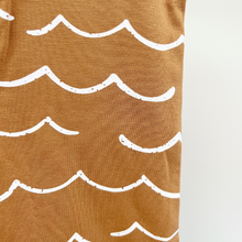 Load image into Gallery viewer, A close-up of a brown cotton fabric with a white hand-drawn wave pattern,used for this summer baby boy jumpsuit.