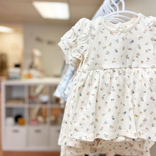 Load image into Gallery viewer, A floral baby dress on a clothing rack inside Gracie Lou, A Boutique For Littles, in Bedford, Pennsylvania.