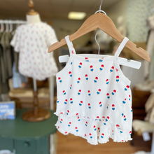 Load image into Gallery viewer, White pointelle baby top and shorts set with bomb pop popsicle print on a wooden hanger displayed inside Gracie Lou children's boutique