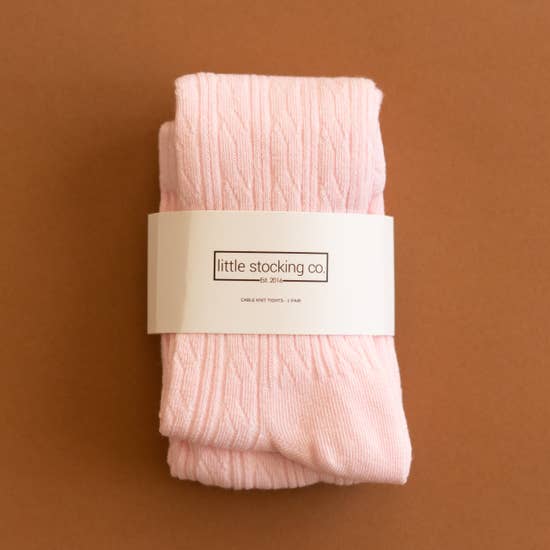 Cable knit tights in the color light pink available at Gracie Lou | A Boutique For Littles